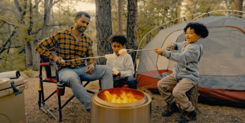 dad roasting marshmallows with kids - winter weekend activities for families